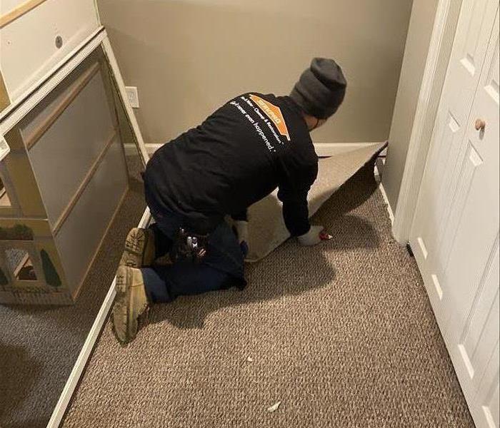 Technician removing carpet